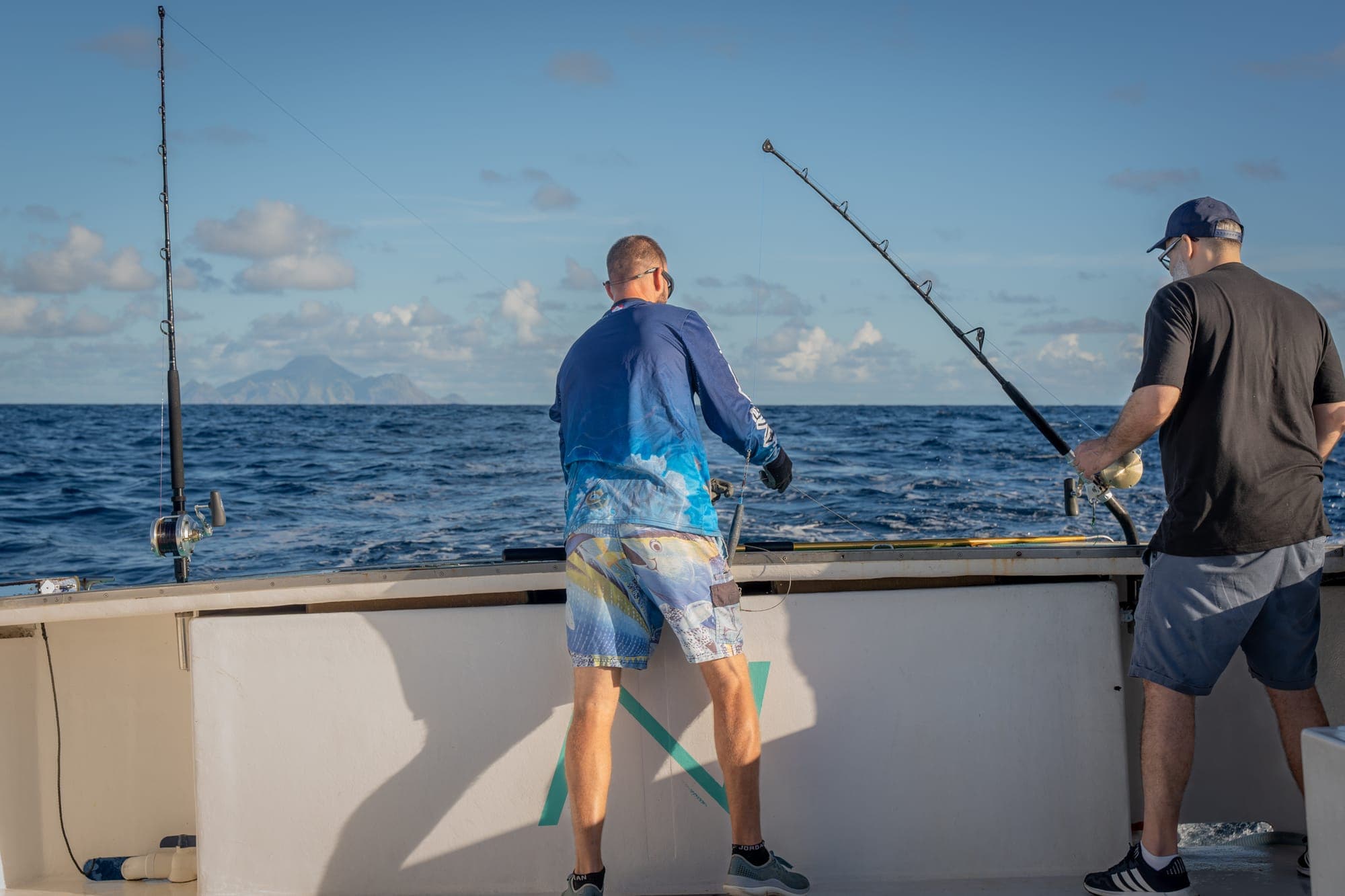 Two people fishing from a boat off the coast of Saba