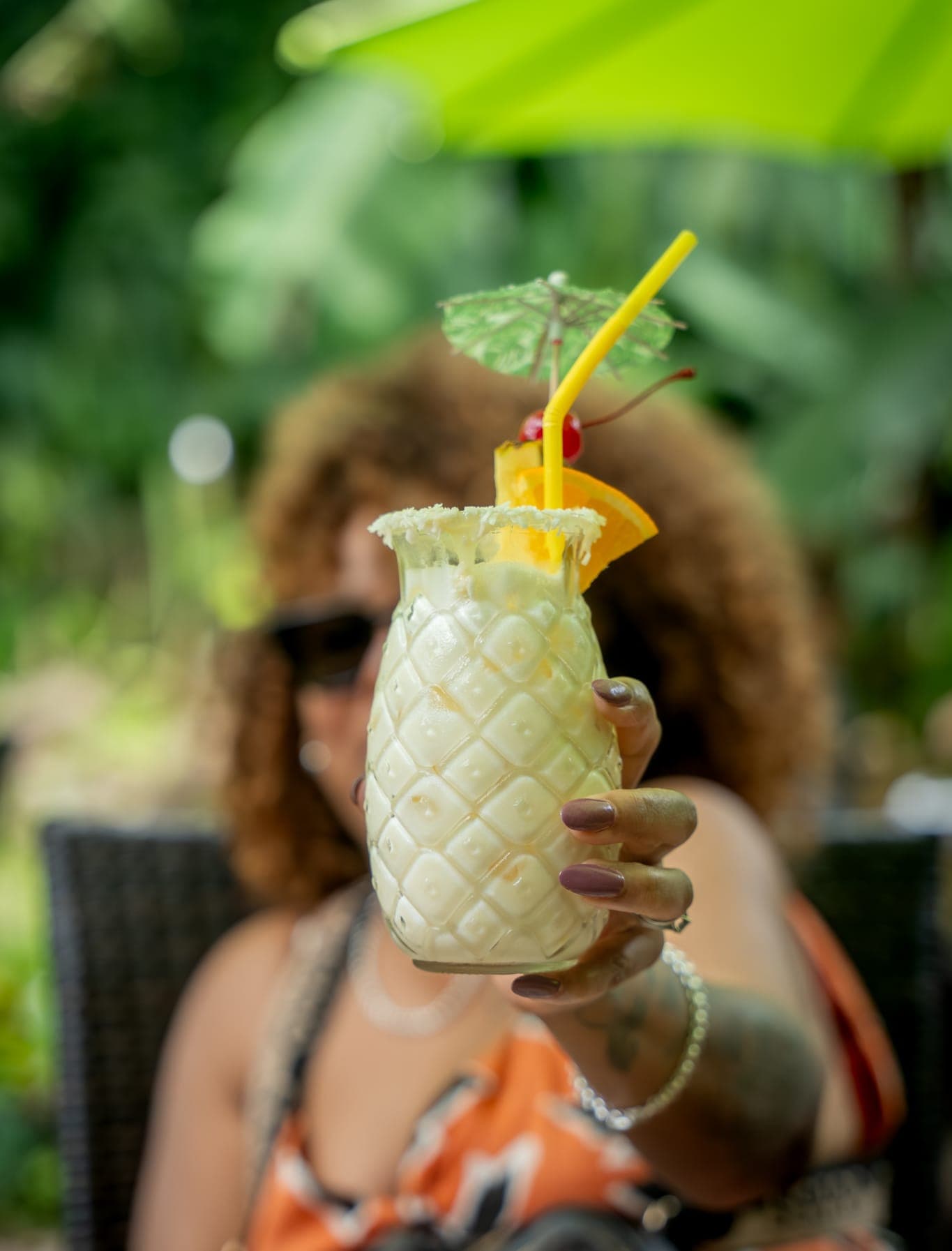 Guests toasting with drinks on a terrace on Saba