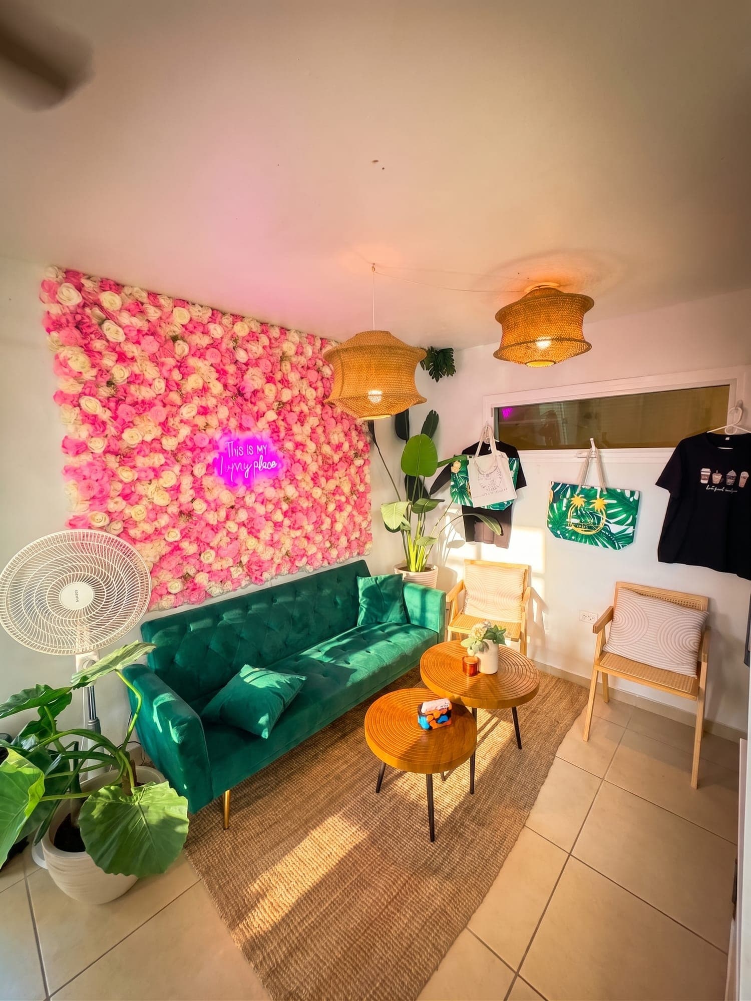 The flower wall and green sofa seating corner