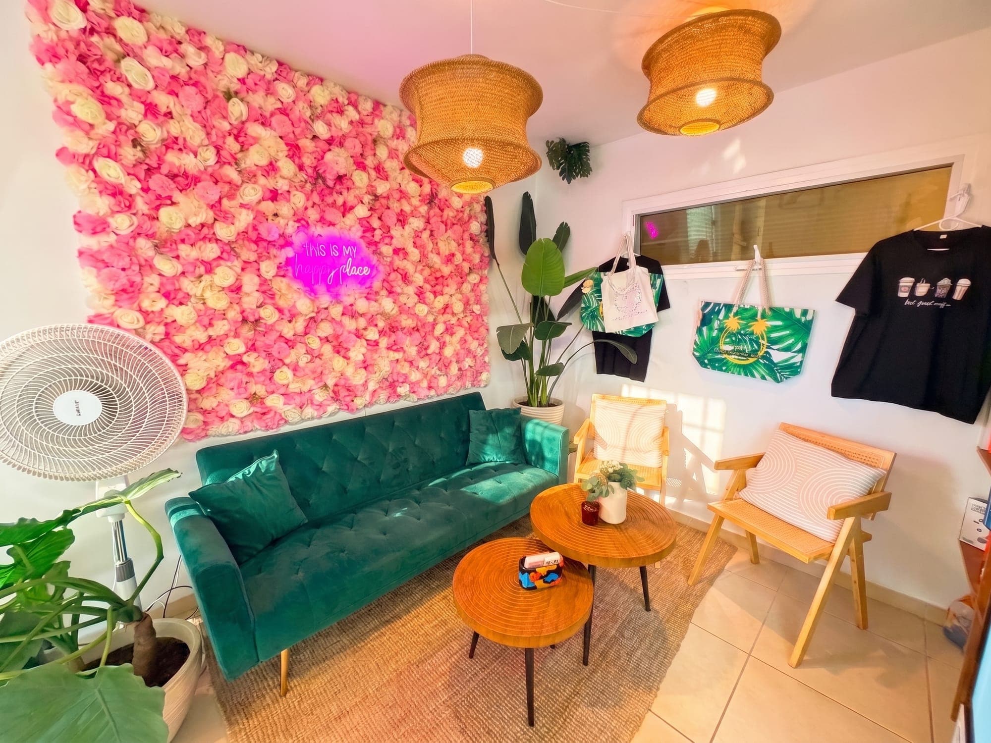 The green velvet sofa against the flower wall inside the cafe