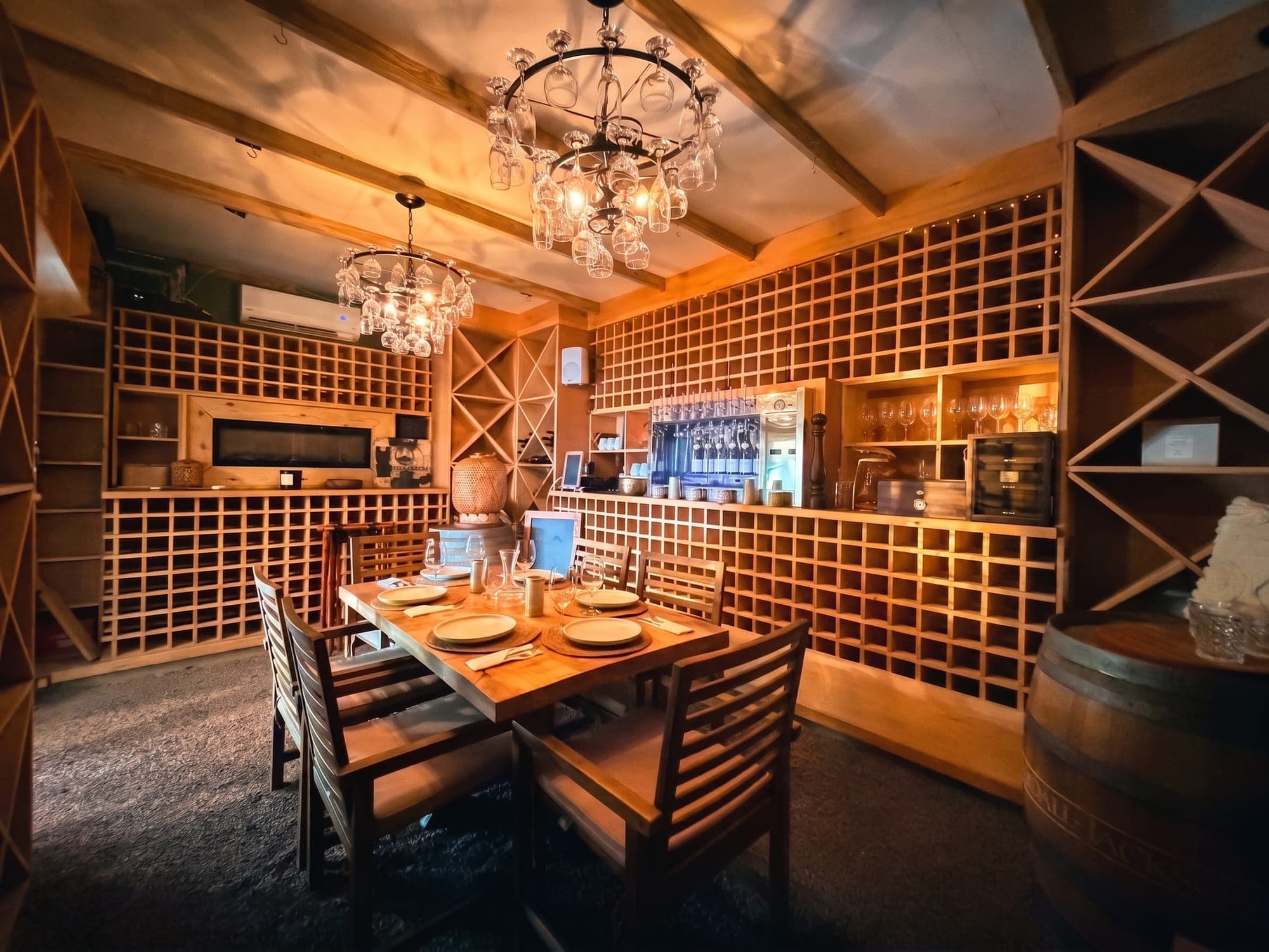A table for two beside the wine wall, under a chandelier