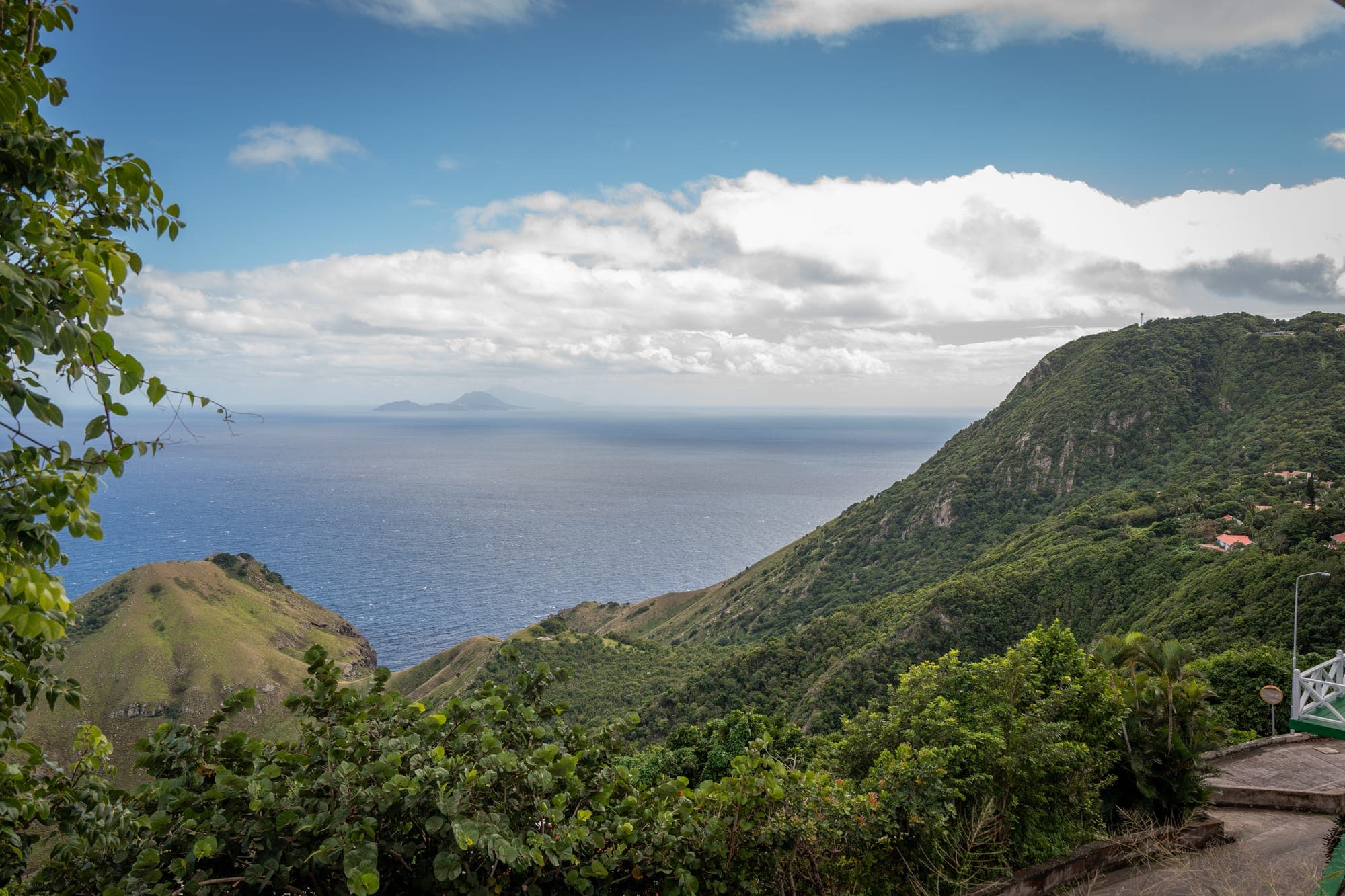 The green coastline of Saba dropping into the Caribbean sea