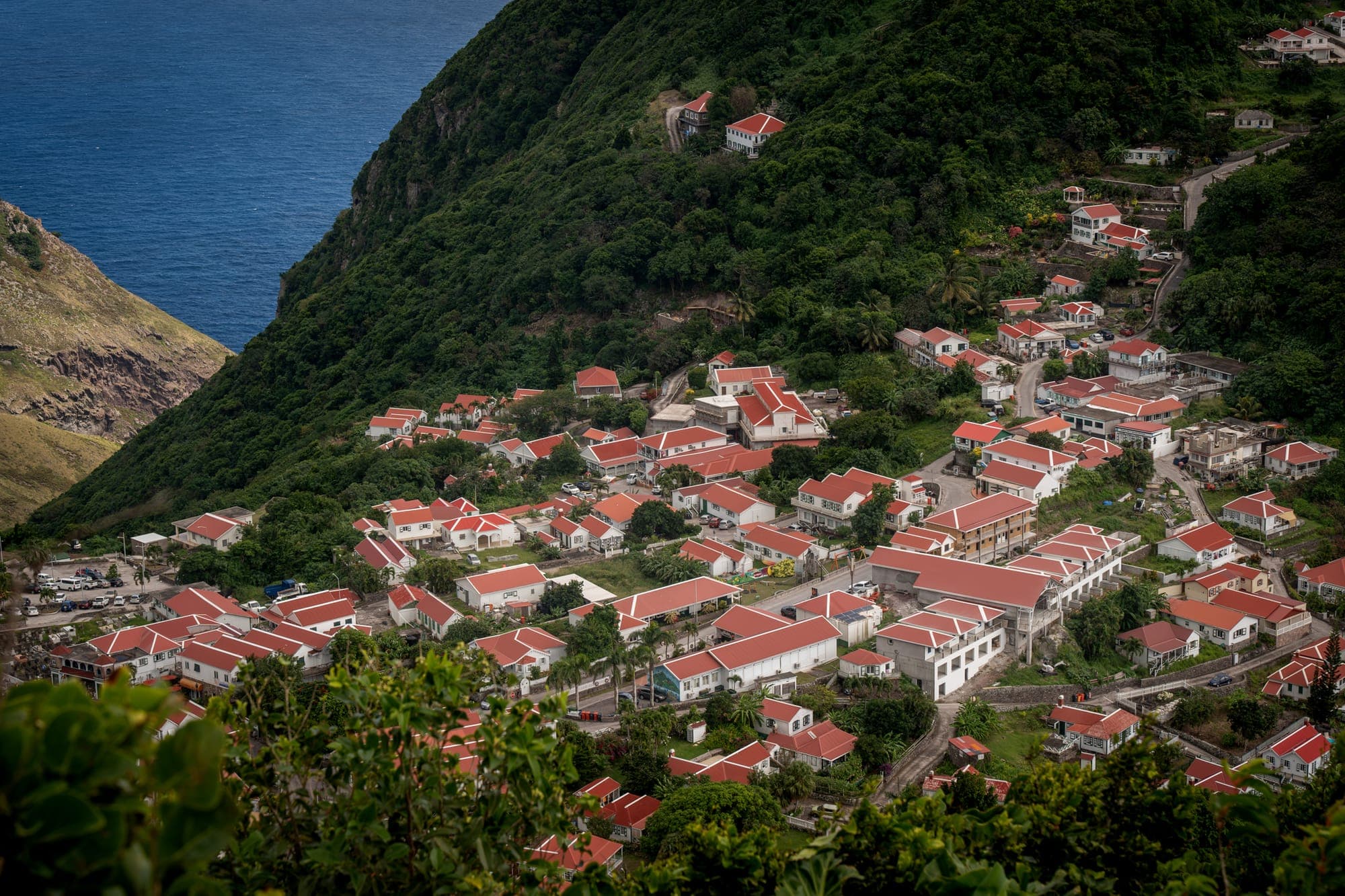 Red roofs of Windwardside against the green slope of Mount Scenery
