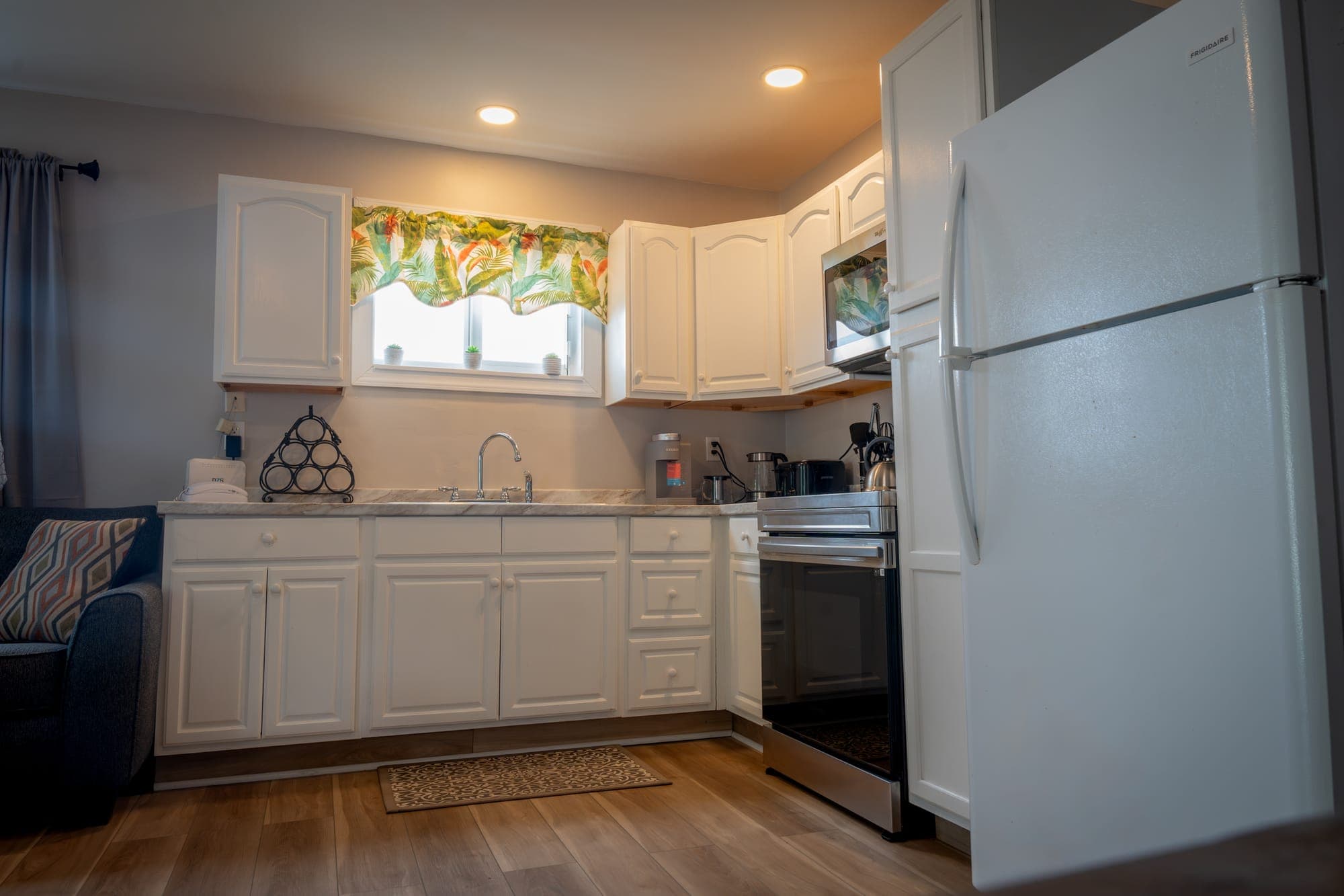 Kitchen of Tropical Paradise with a breakfast bar