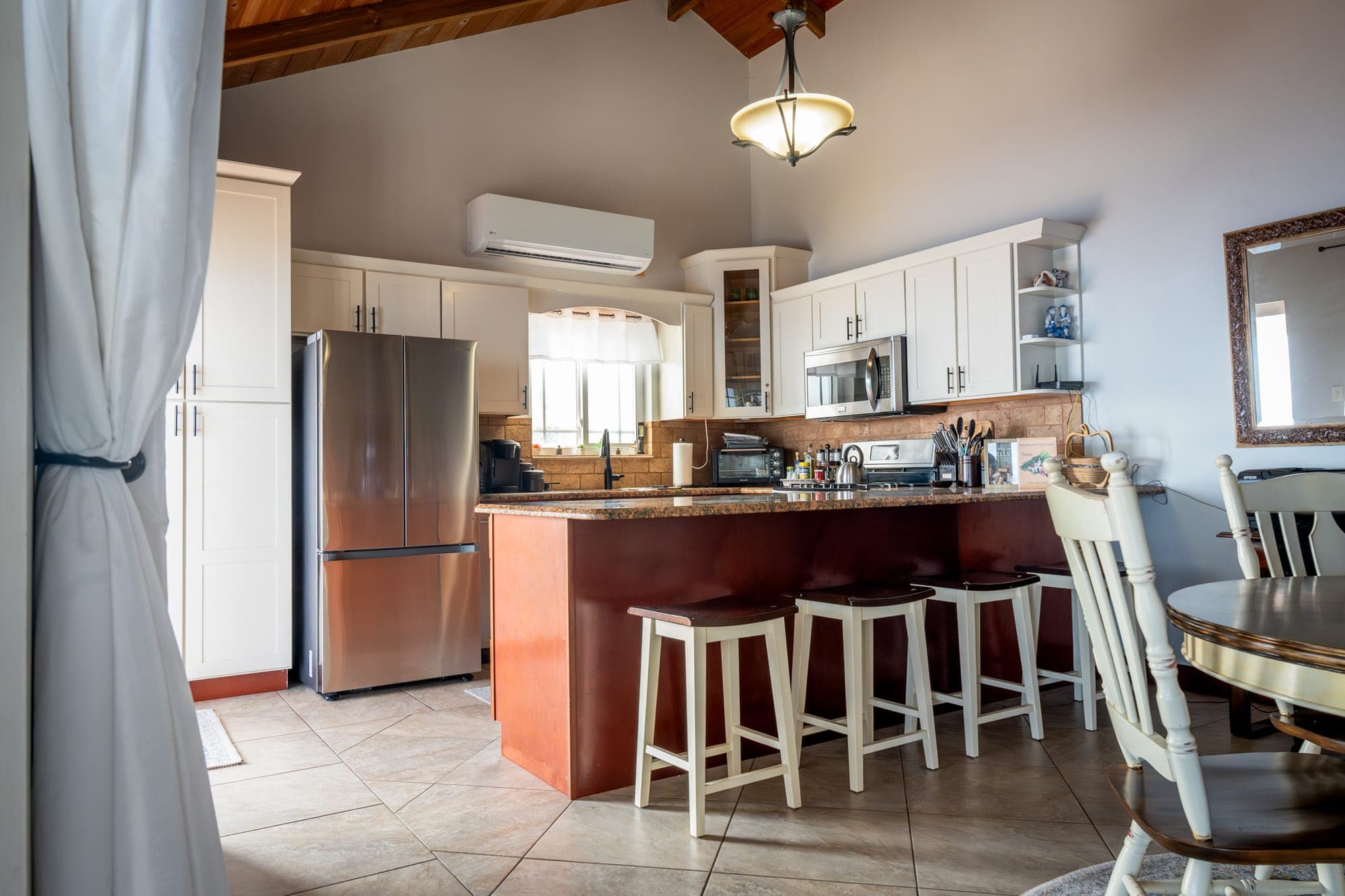 Kitchen of Tropical Paradise with a breakfast bar